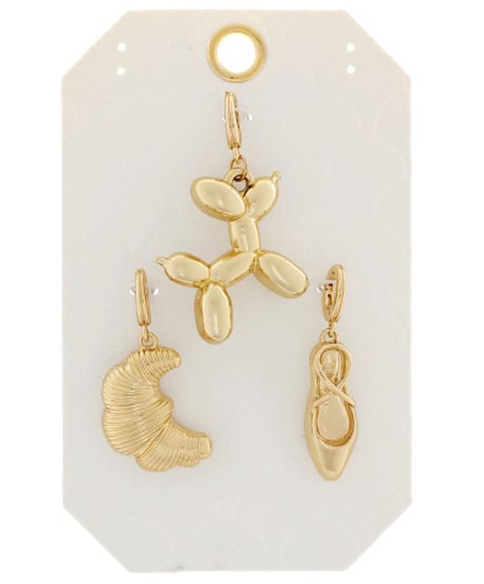 Whimsical Wonders Charm Set featuring three gold charms: a balloon dog, a croissant, and a ballet slipper.