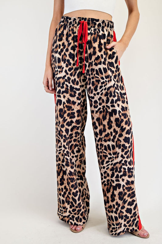 leopard print wide-leg pants with red side stripe.