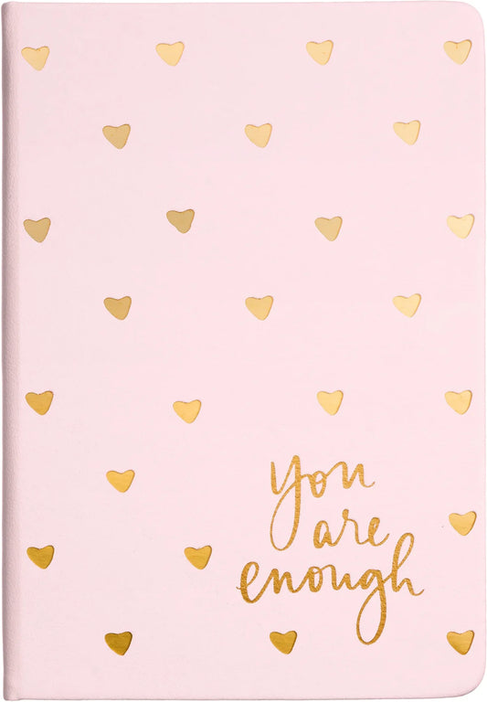 "Elegant pink hardcover journal with gold foil hearts and an empowering 'You Are Enough' message, designed for daily journaling and inspiration."