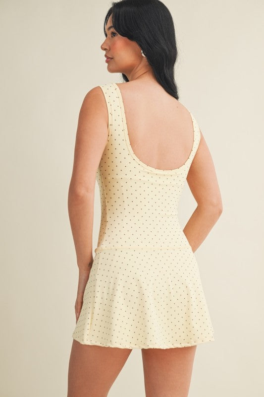 polka dot A-line mini dress with drop waist, soft stretch-knit fabric, and relaxed fit
