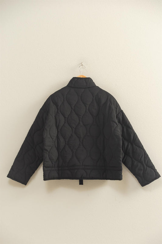 The Evadne Quilted Drawstring Jacket delivers cozy structure with a modern relaxed fit.