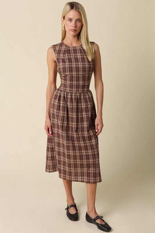 A romantic gingham maxi dress featuring an open-back tie detail, flattering fit-and-flare silhouette, and timeless plaid pattern for effortless feminine style.