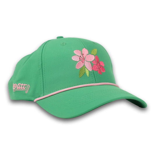A green baseball cap with pink azalea flower embroidery, featuring a curved brim and an adjustable strap for a comfortable fit.