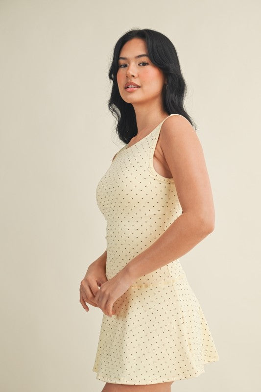 polka dot A-line mini dress with drop waist, soft stretch-knit fabric, and relaxed fit