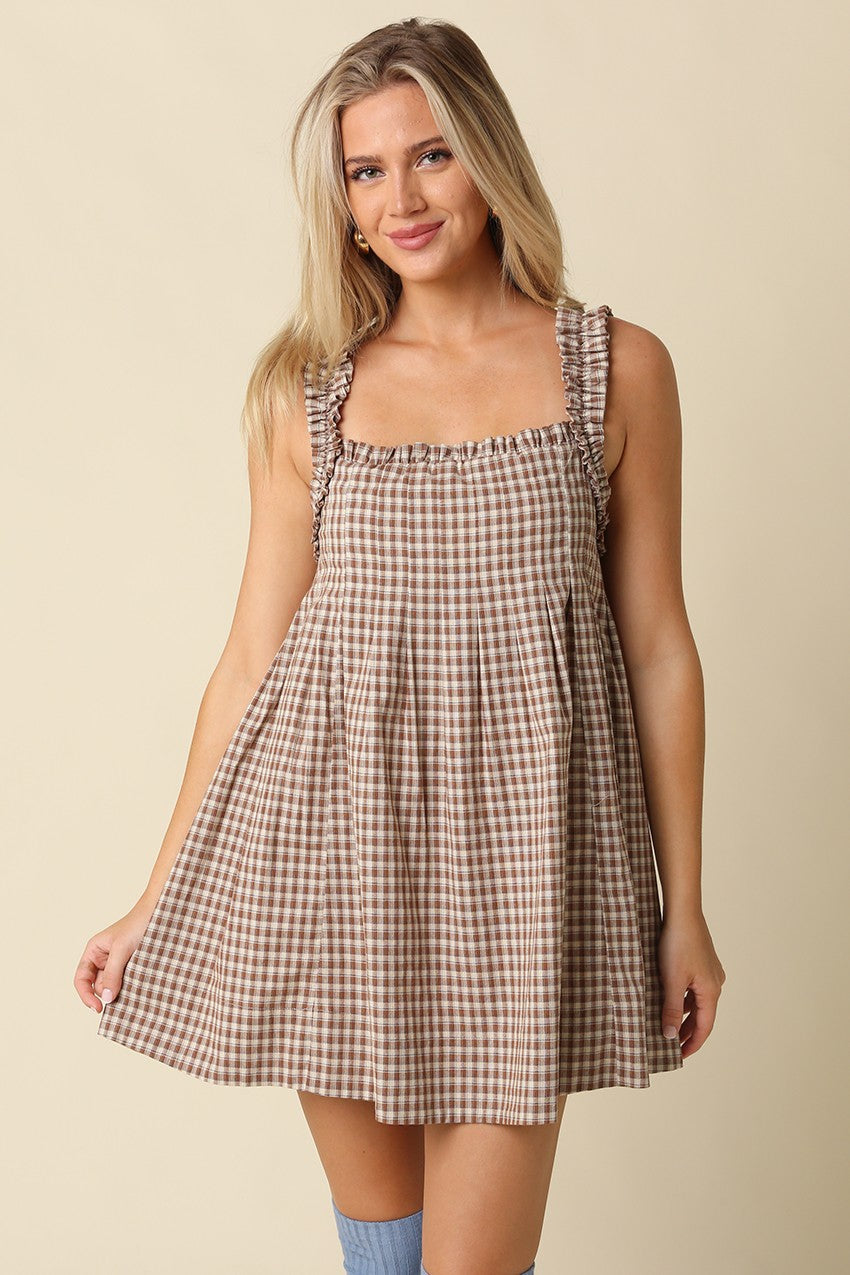 A sweet gingham babydoll mini dress featuring a flowy silhouette, ruffled shoulder straps, and lightweight cotton comfort for effortless warm-weather style.