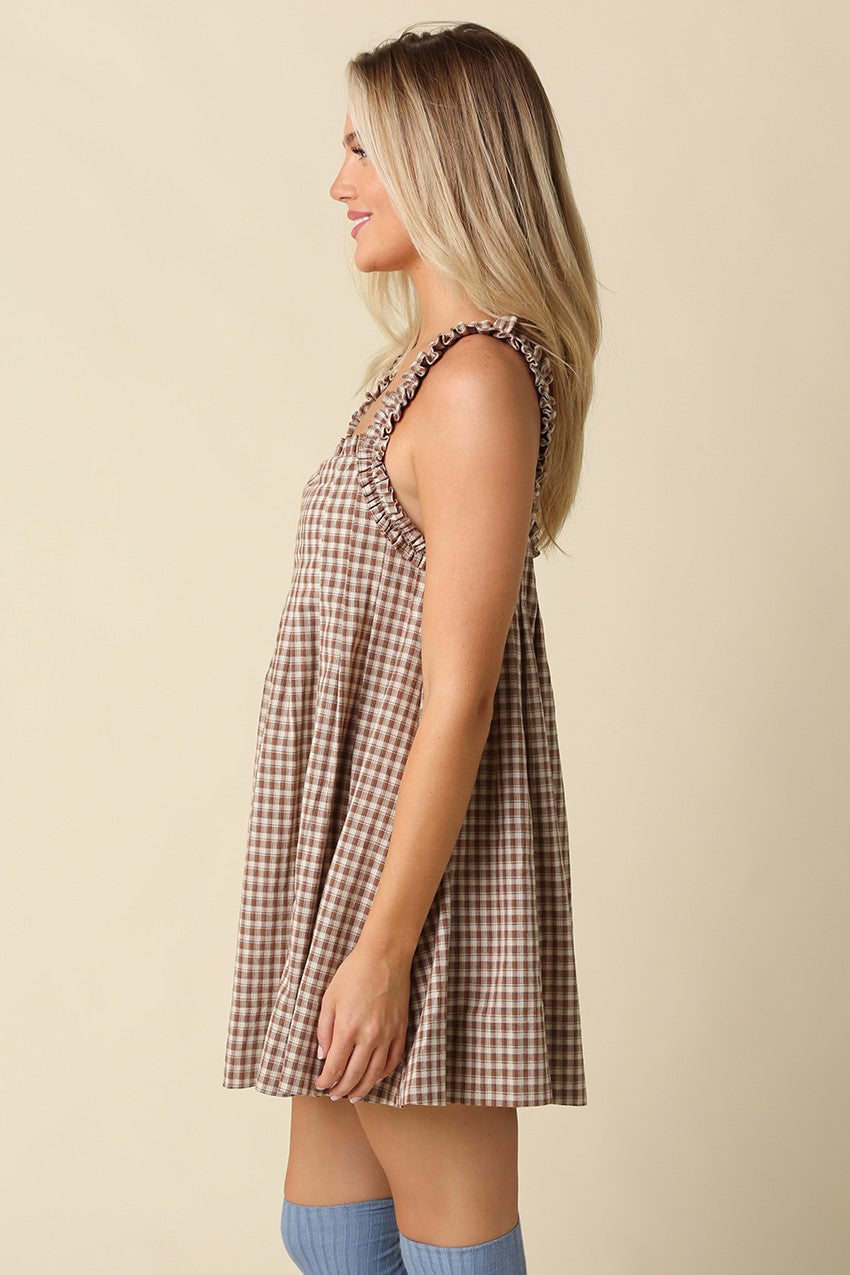 A sweet gingham babydoll mini dress featuring a flowy silhouette, ruffled shoulder straps, and lightweight cotton comfort for effortless warm-weather style.