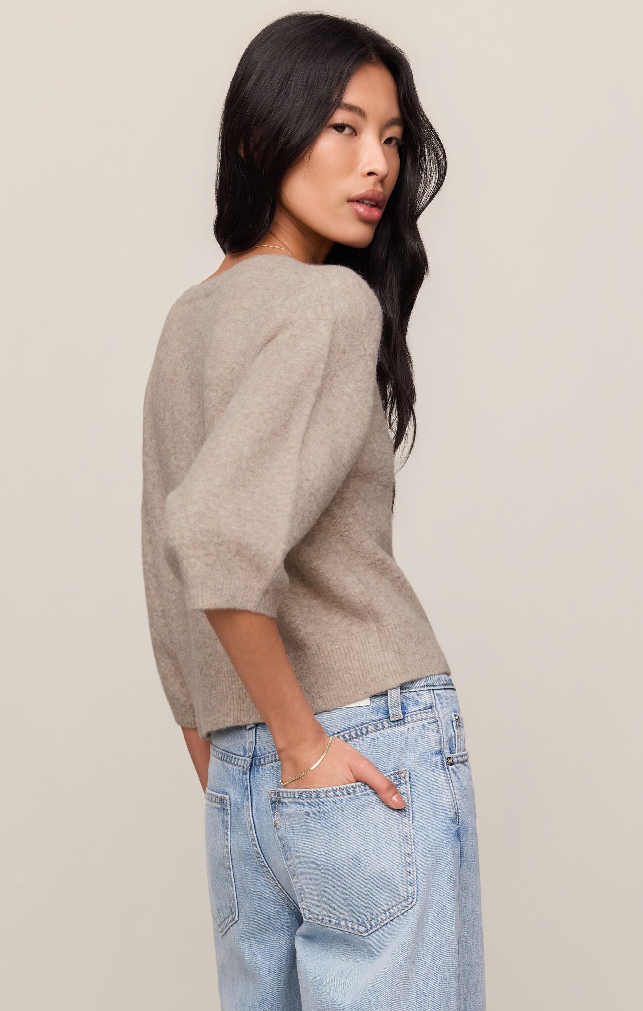 A soft knit button-front top featuring a classic crew neckline, ¾ sleeves, and a lightweight stretch fabric for effortless everyday layering.