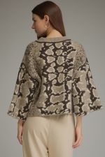 A stylish abstract print knit top featuring a classic round neckline, relaxed wide sleeves, and a cozy medium-weight feel.

