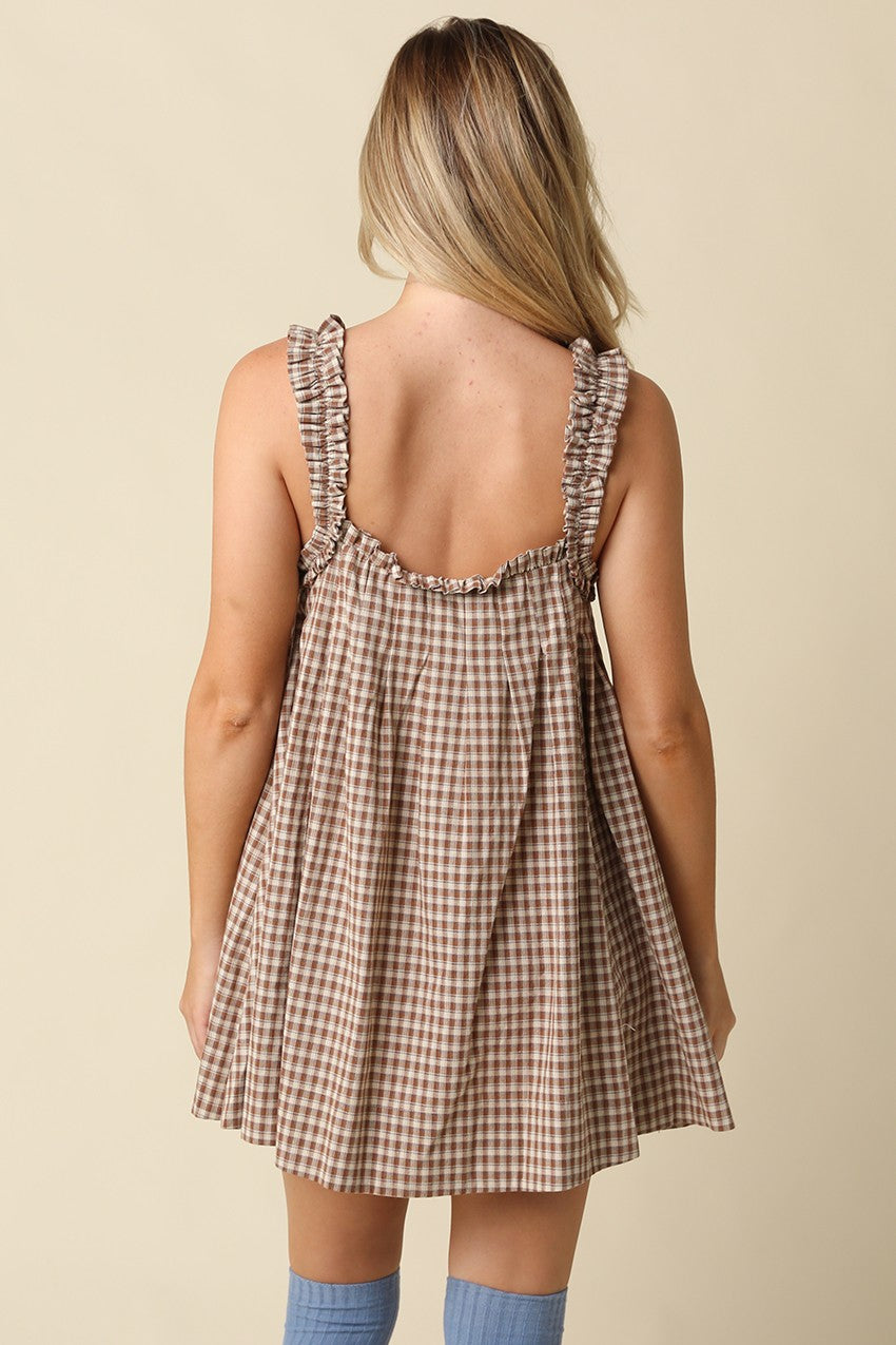 A sweet gingham babydoll mini dress featuring a flowy silhouette, ruffled shoulder straps, and lightweight cotton comfort for effortless warm-weather style.