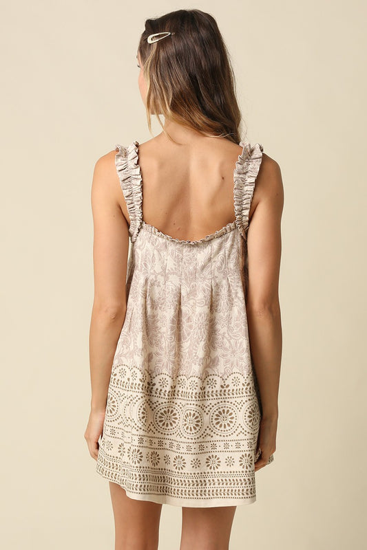 A breezy printed babydoll mini dress featuring a vintage-inspired print, ruffled shoulder straps, and a relaxed linen-blend silhouette made for effortless warm-weather style.
