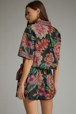 A feminine botanical print two-piece set featuring a breezy split-V top and wrap-front skort for effortless warm-weather style.