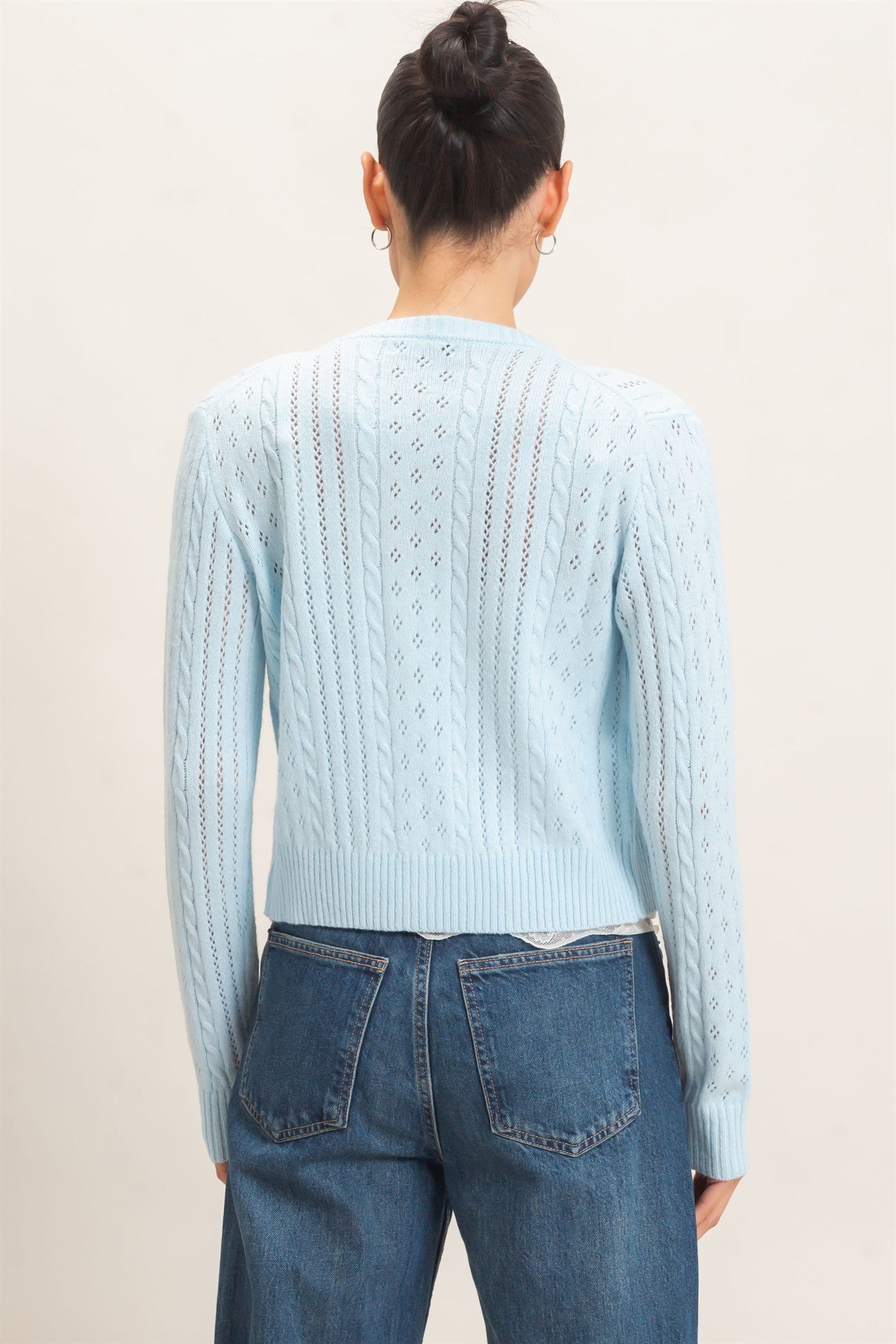 A timeless cable knit cardigan with a classic crew neckline, button-front closure, and textured detailing for cozy, polished style.