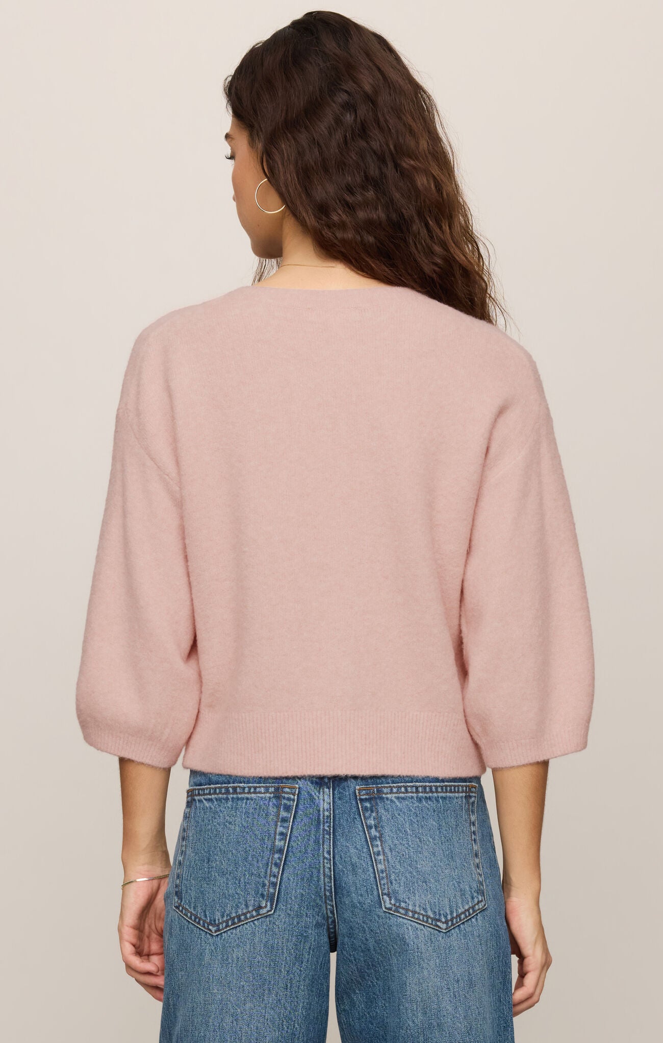 A soft knit button-front top featuring a classic crew neckline, ¾ sleeves, and a lightweight stretch fabric for effortless everyday layering.