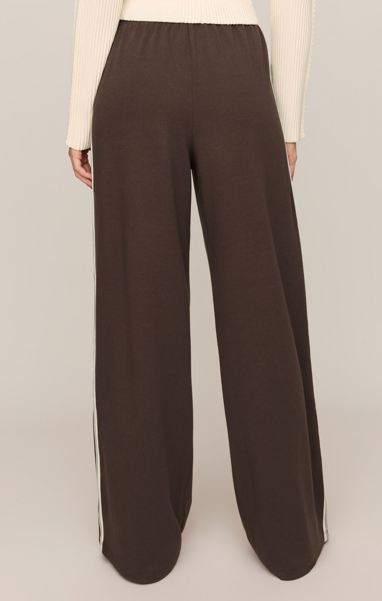 Effortlessly polished and incredibly comfortable, these high-rise knit lounge pants feature a relaxed silhouette, adjustable drawcord waist, and functional pockets for everyday versatility.