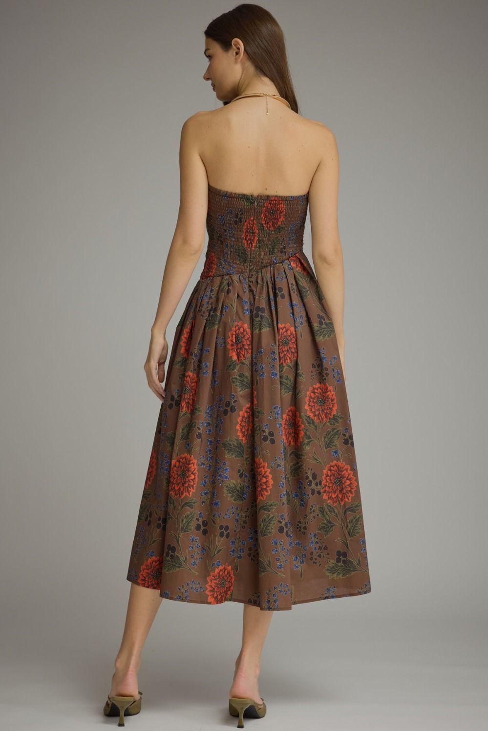 A feminine floral midi dress featuring a unique neckline created by the beautifully pleated bodice, comfortable smocked back, and convenient side pockets.
