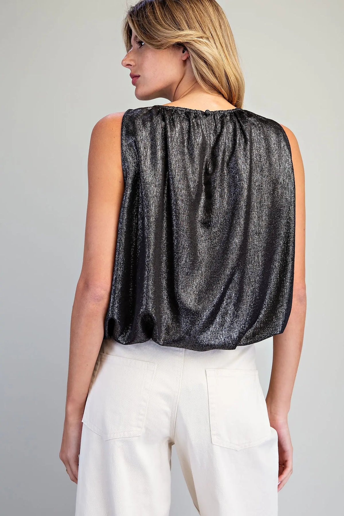 Add a touch of modern elegance to any outfit with this shimmery bubble hem tank top featuring a gathered neckline and sophisticated back keyhole detail.