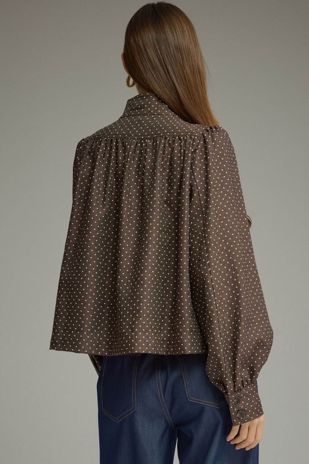 A chic polka dot jacket featuring a polished stand collar, gathered shoulder details, and classic button-front styling in lightweight woven fabric.

