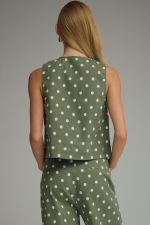 A timeless polka dot sleeveless top with a classic round neckline and button-front detail for effortless everyday style.
