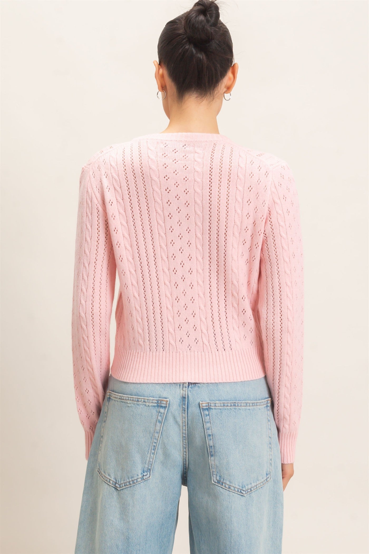 A timeless cable knit cardigan with a classic crew neckline, button-front closure, and textured detailing for cozy, polished style.