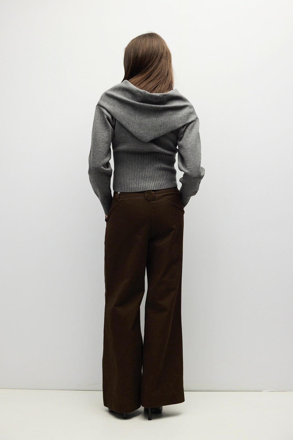 A timeless midweight knit cardigan featuring a polished crew neckline, full button front, and a flattering ribbed waist for effortless everyday sophistication.