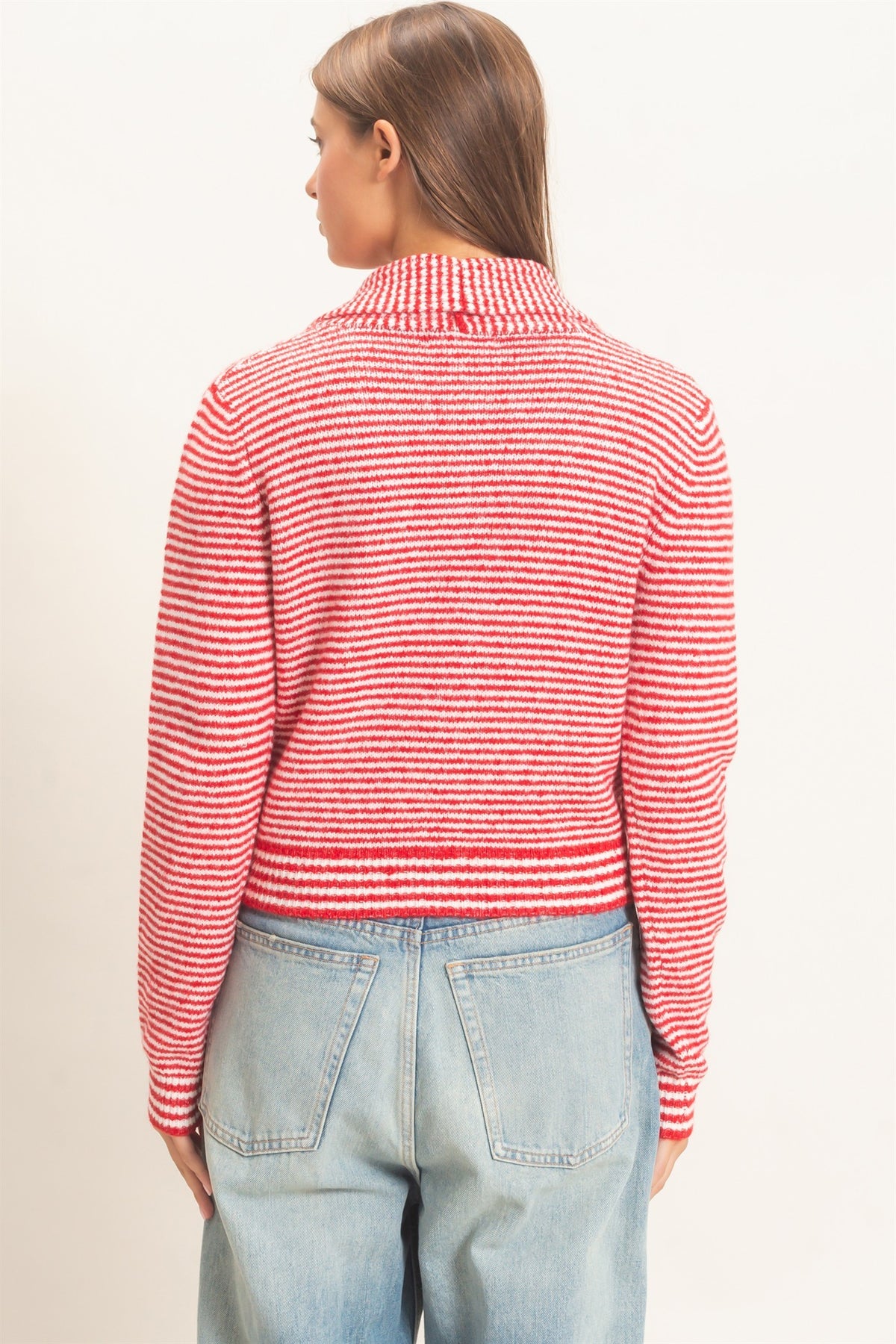 A chic striped knit sweater featuring a full button-up front and attached scarf neckline for a polished, modern layered look.

