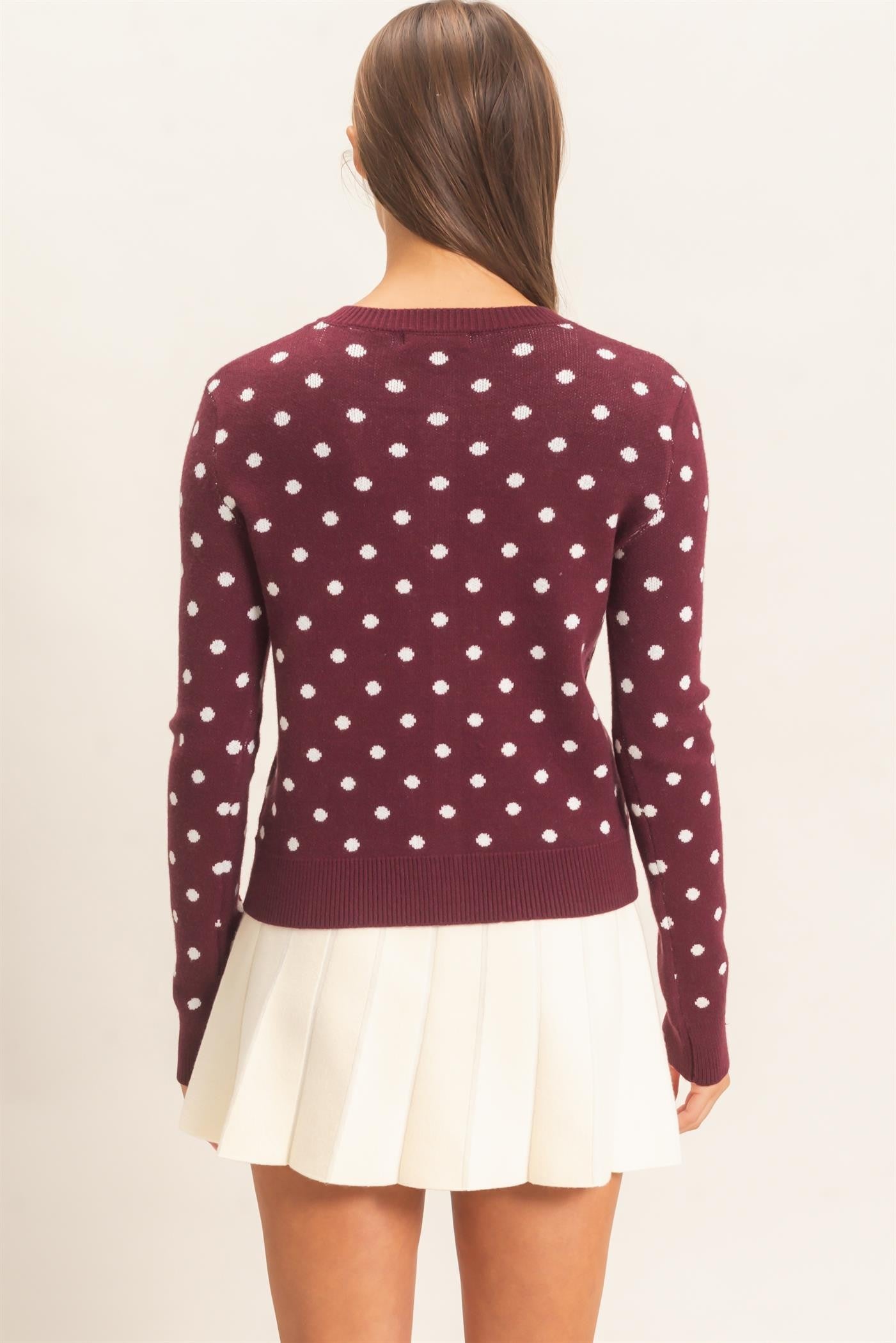 A timeless polka dot cardigan with a classic crew neckline and button-front design that adds effortless charm to everyday and office-ready looks.
