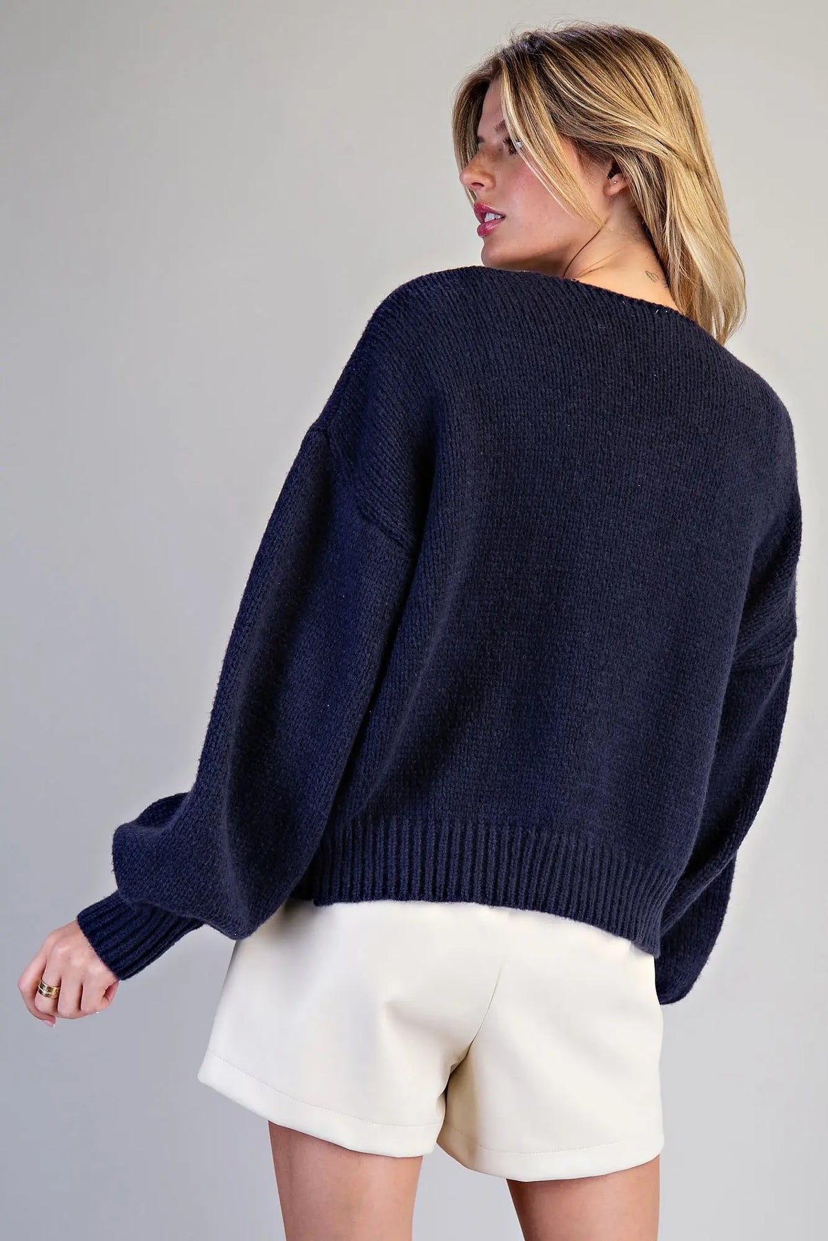 A cozy holiday cardigan featuring scattered knit Christmas trees, a flattering V-neckline, and feminine tie-front closures.