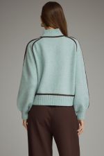 A cozy mock neck sweater featuring statement balloon sleeves, contrast trim throughout, and ribbed finishing for a polished seasonal look.

