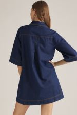 A playful printed mini dress featuring a polished collar, V-neckline, contrast topstitching, and convenient side pockets for effortless everyday style.

