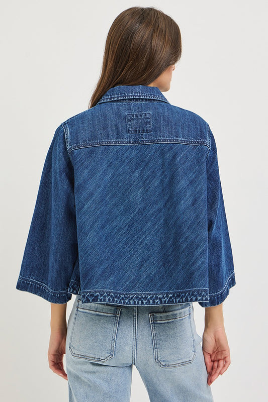 The Bernadette Flowy Cropped Denim Jacket gives classic denim a fresh feminine update with a wide, relaxed silhouette, button front, and voluminous sleeves.