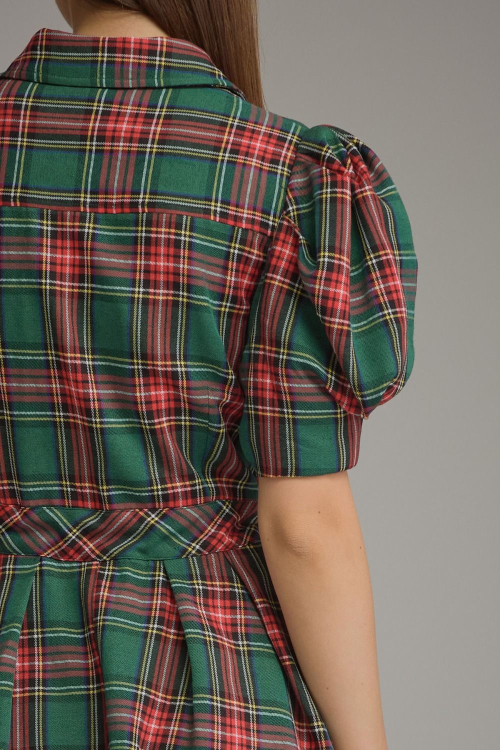 A charming plaid mini dress featuring feminine puff sleeves, a classic shirt collar, and a self-tie waist for a flattering silhouette.

