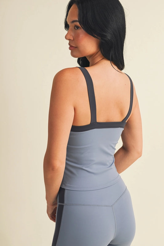 A sleek, sporty tank featuring a flattering scoop neckline, modern contrast color-blocking, and a fitted silhouette designed for effortless studio-to-street style.


