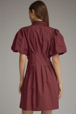 The Winifred Eyelet Collar Mini Dress combines romantic puff sleeves, delicate eyelet details, and a flattering pleated waist for effortlessly feminine style.