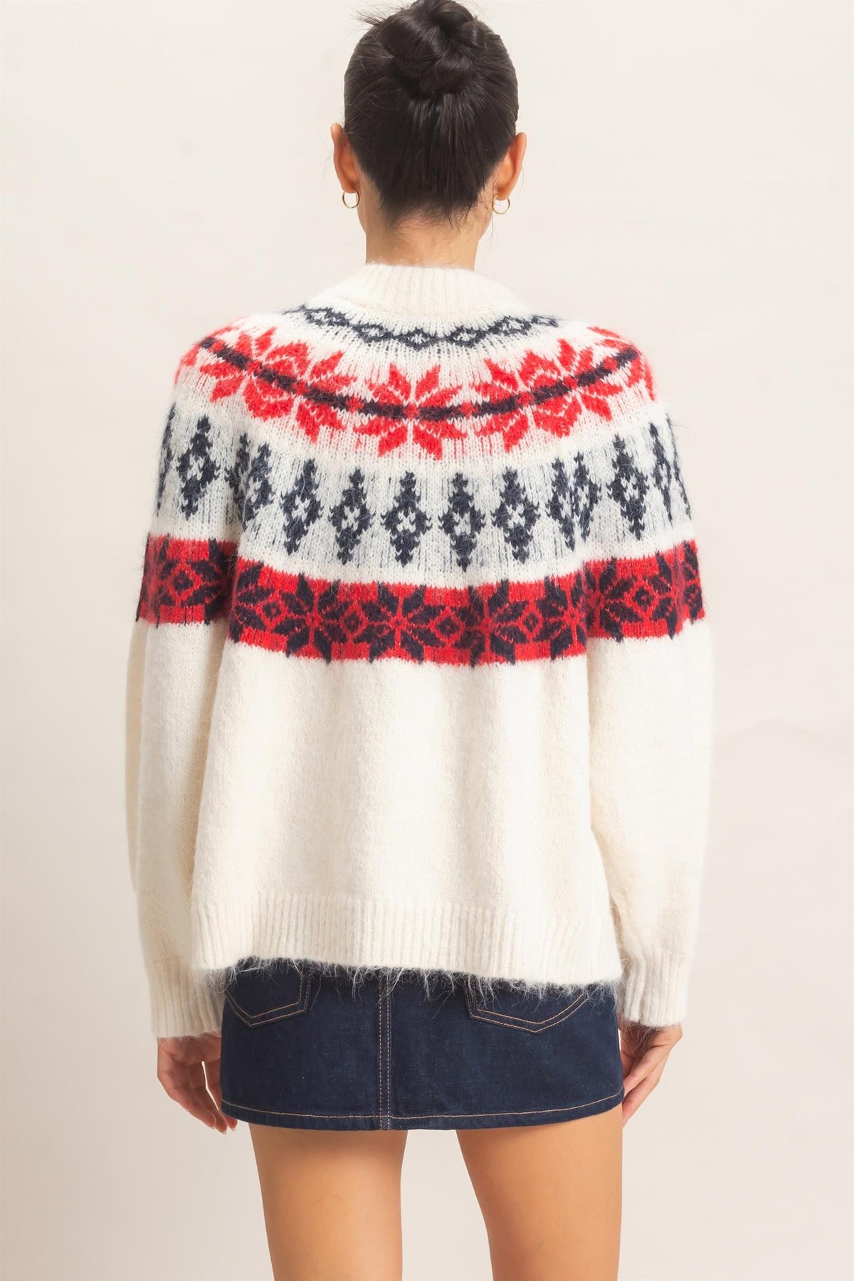 A cozy Fair Isle cardigan featuring classic snowflake motifs, a soft fuzzy texture, and a relaxed button-front silhouette perfect for chilly days.