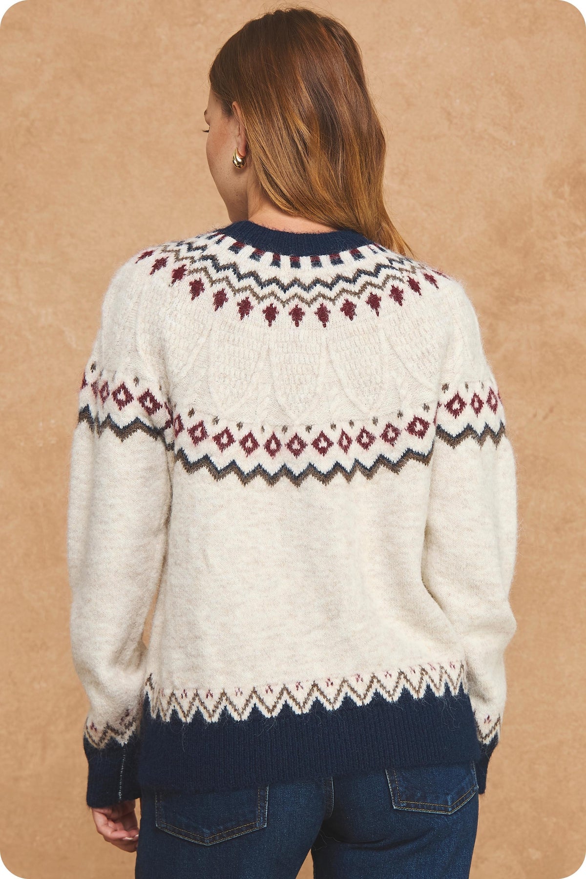 Stay cozy in vintage-inspired style with a soft Fair Isle sweater featuring a cream knit base, rich seasonal colors, and contrasting navy ribbed trim.

