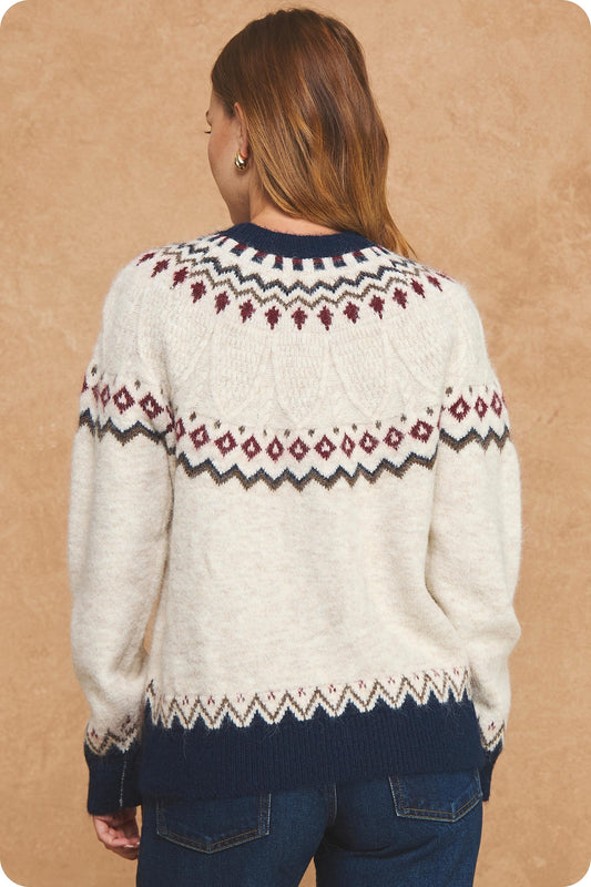 Stay cozy in vintage-inspired style with a soft Fair Isle sweater featuring a cream knit base, rich seasonal colors, and contrasting navy ribbed trim.

