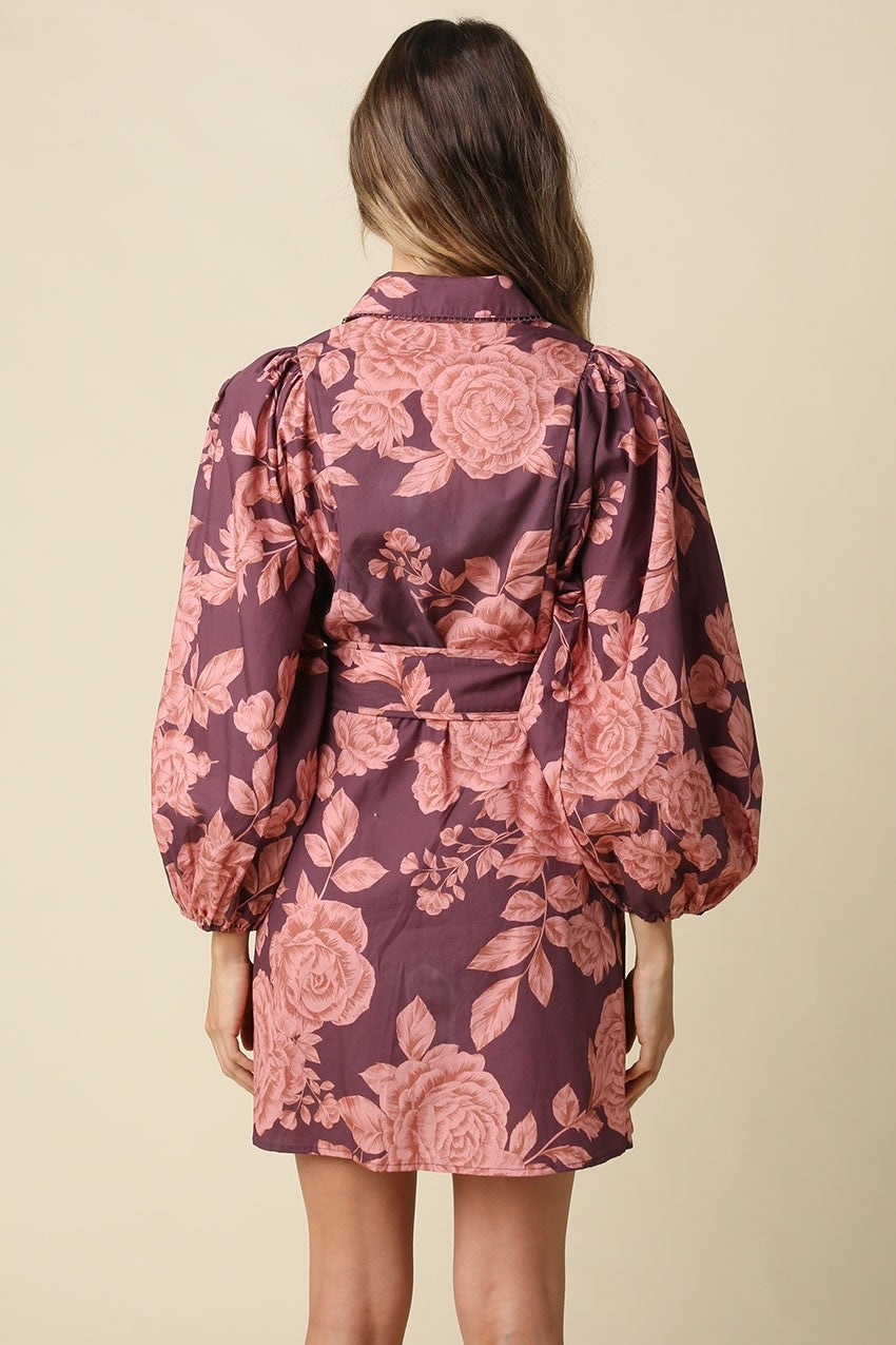 The Estelle Floral Belted Mini Dress combines a romantic floral print, voluminous puff sleeves, and a defined belted waist for effortlessly feminine style.