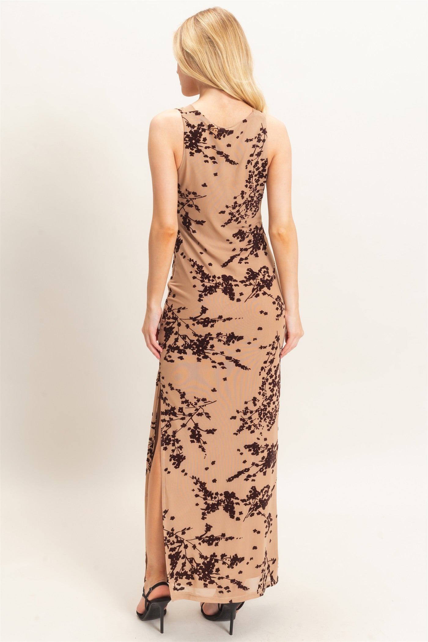 A sophisticated sleeveless dress featuring an elegant draped cowl neckline and subtle floral flocking for an effortlessly chic finish.

