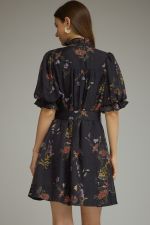 A romantic floral mini dress featuring puff sleeves, a self-tie waist belt, and a ruffled V-neckline for effortlessly feminine style.
