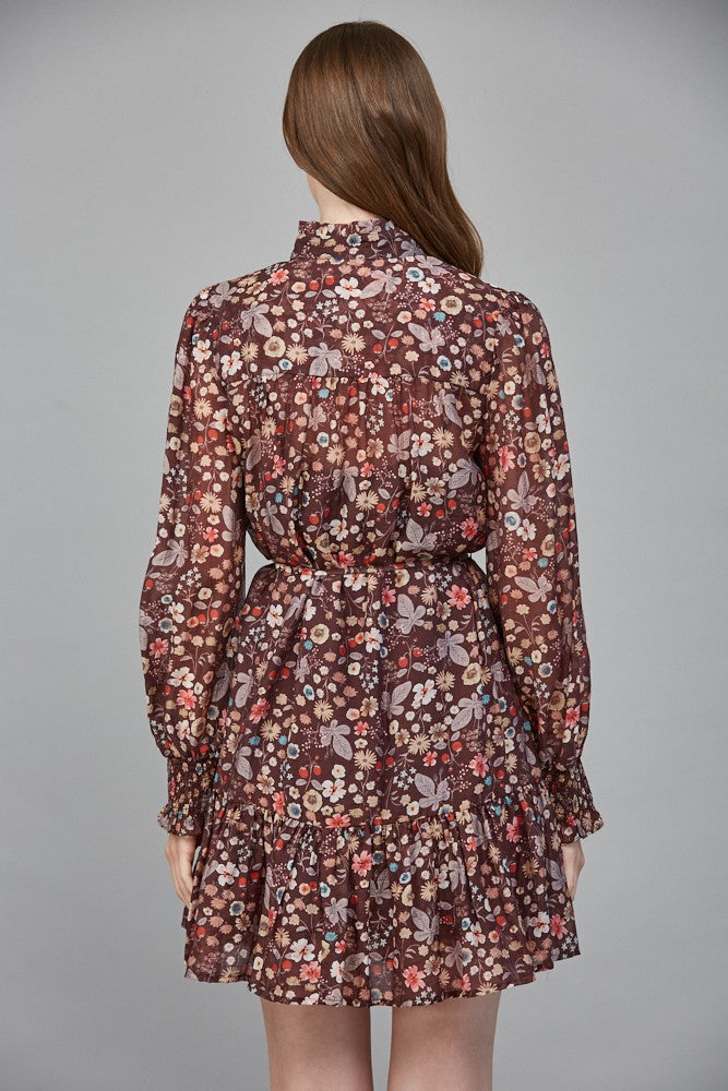 A romantic floral print dress featuring a ruffled high neckline, flattering tie waist, and flowing silhouette for effortlessly elegant style.
