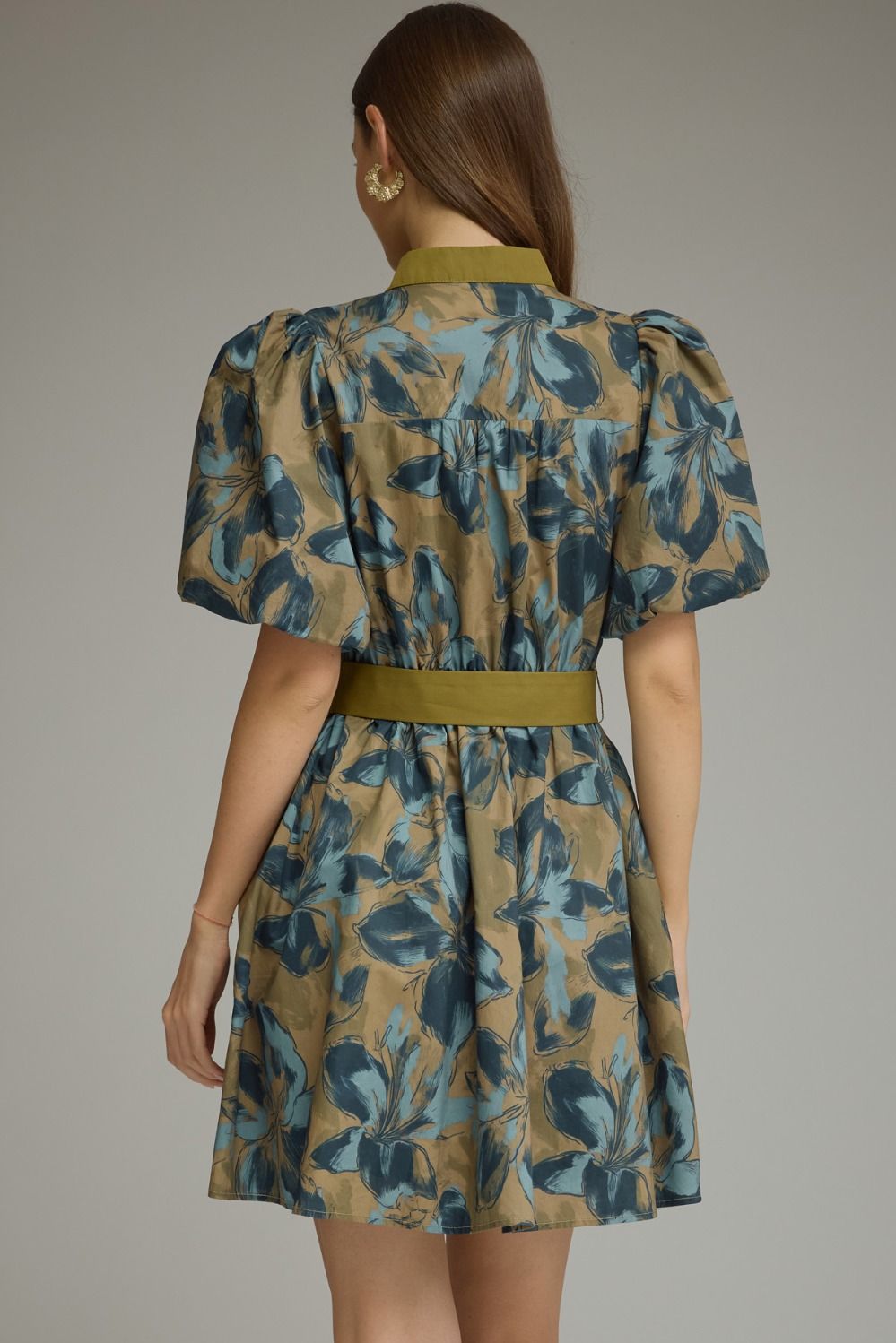 A charming floral mini dress featuring puff sleeves, a button-front design, and a self-tie waist for effortless feminine style.