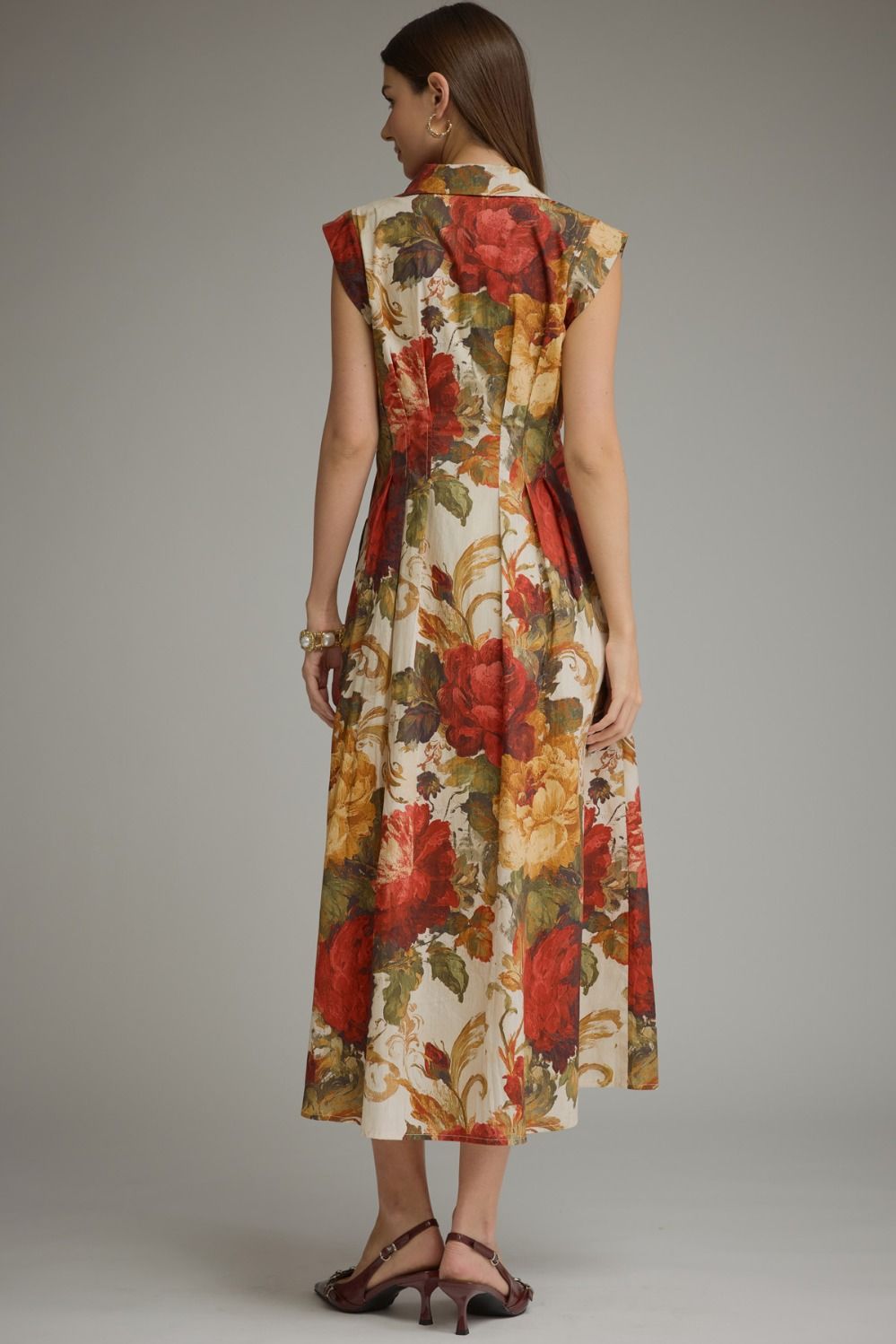 A feminine floral midi dress featuring a flattering foldover neckline, convenient front zipper, and effortless everyday elegance.