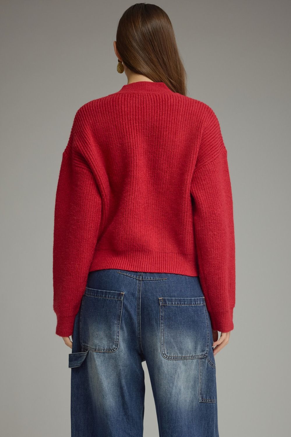 A cozy, polished sweater featuring a high neckline, statement frog-button closure, and relaxed drop shoulders for timeless style with a modern twist.

