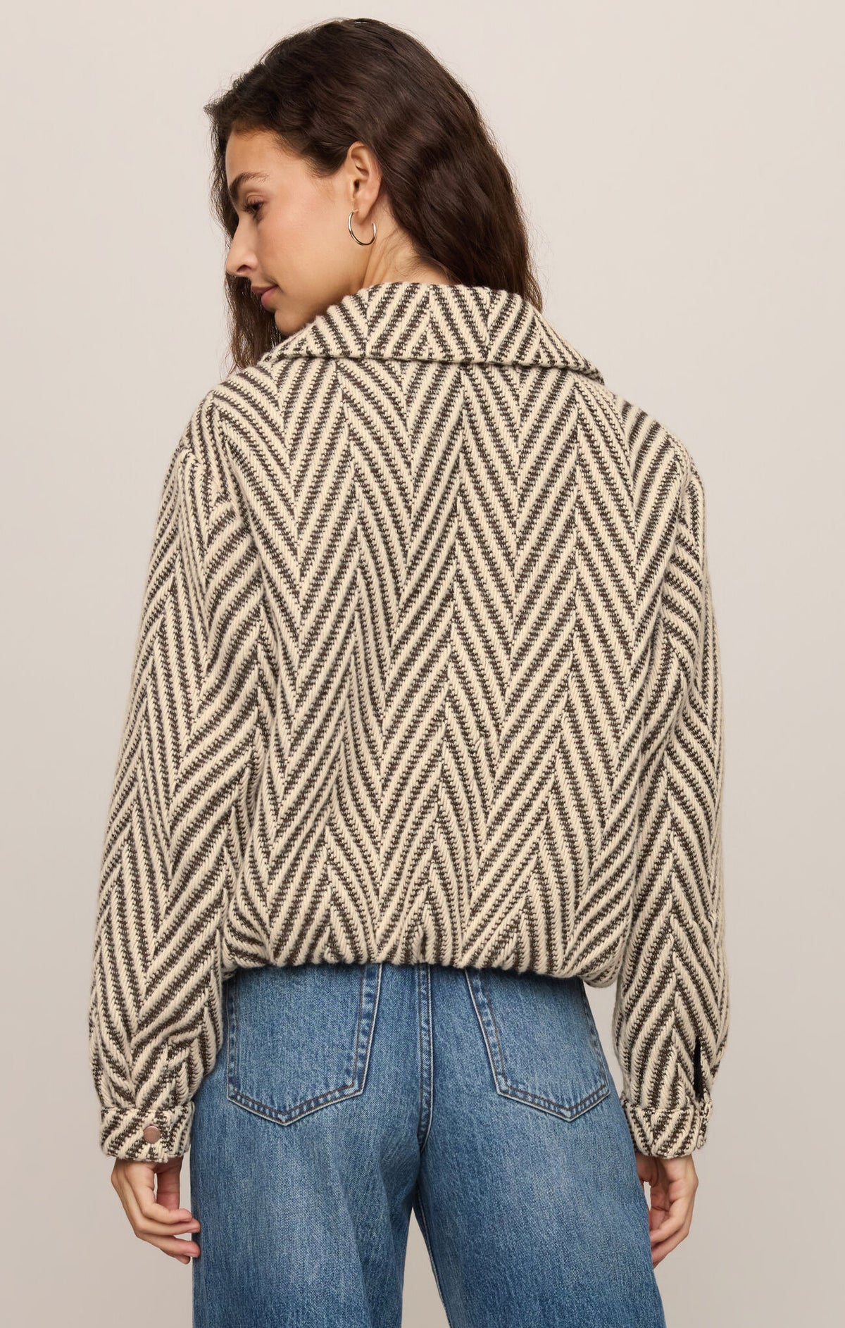 A polished herringbone jacket featuring a classic collar, long sleeves, zip-front closure, and welt pockets for timeless everyday style.