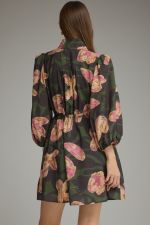 A feminine printed mini dress featuring ¾ balloon sleeves, a stand collar, adjustable drawstring waist, and convenient side pockets.

