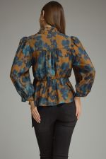A feminine floral peplum top featuring romantic balloon sleeves, a stand collar, and a flattering tie waist for a beautifully defined silhouette.a