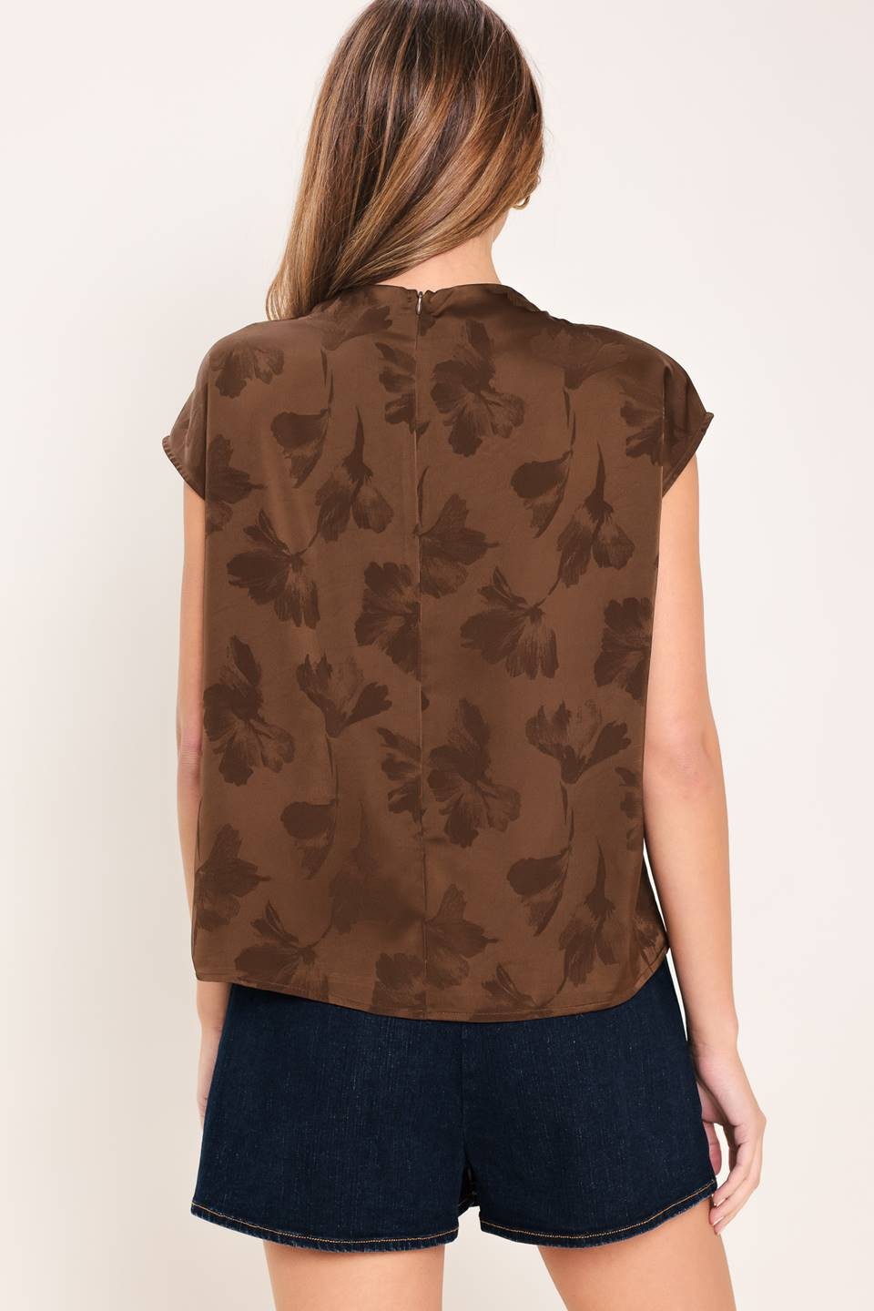 Chic woven jacquard top featuring a sophisticated funnel neckline, short sleeves, and a polished back zipper closure.
