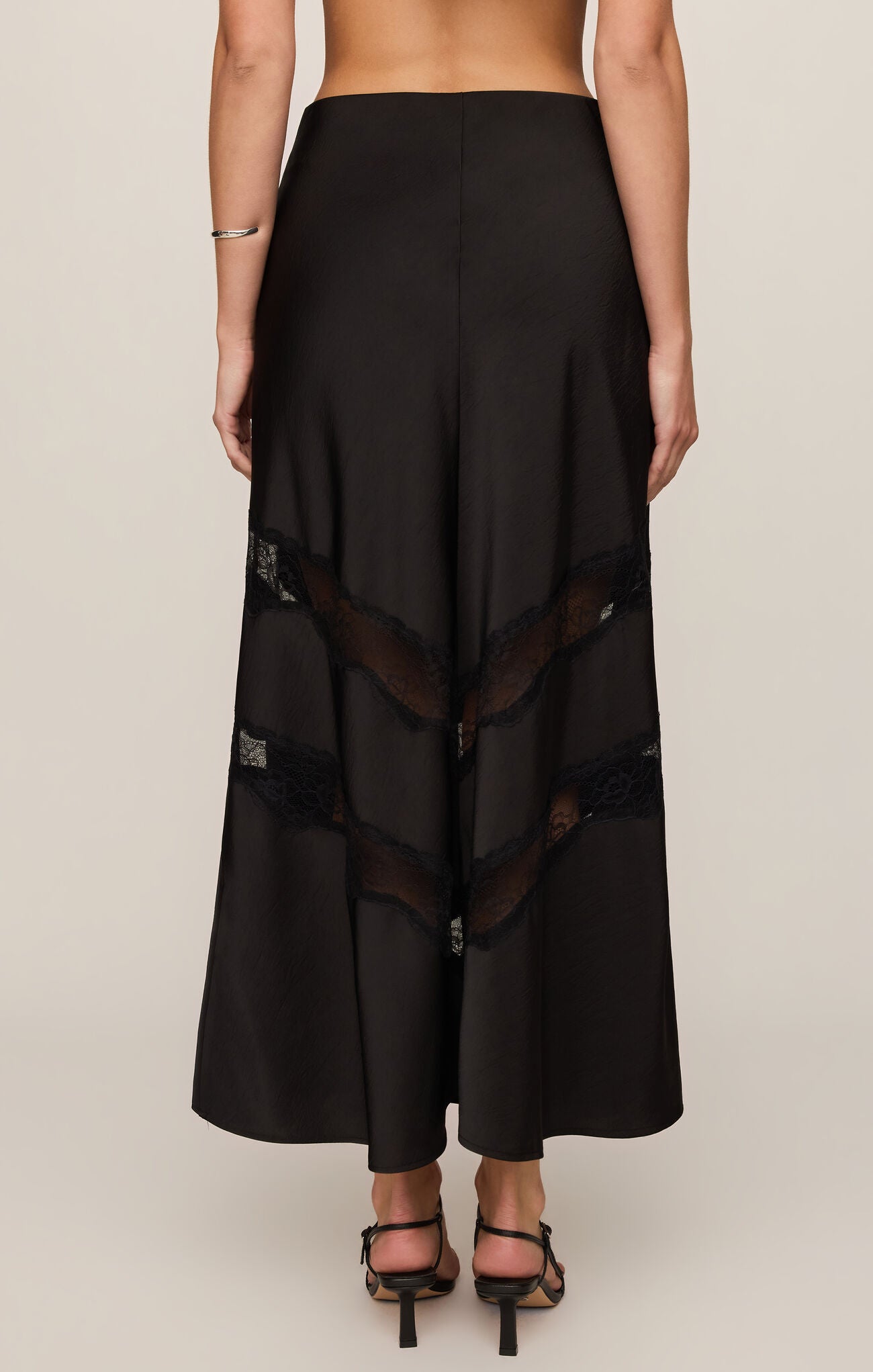 The Kori Lace Inset Skirt combines luxe satin with a flattering high-rise fit and elegant lace detailing for an effortlessly feminine statement.