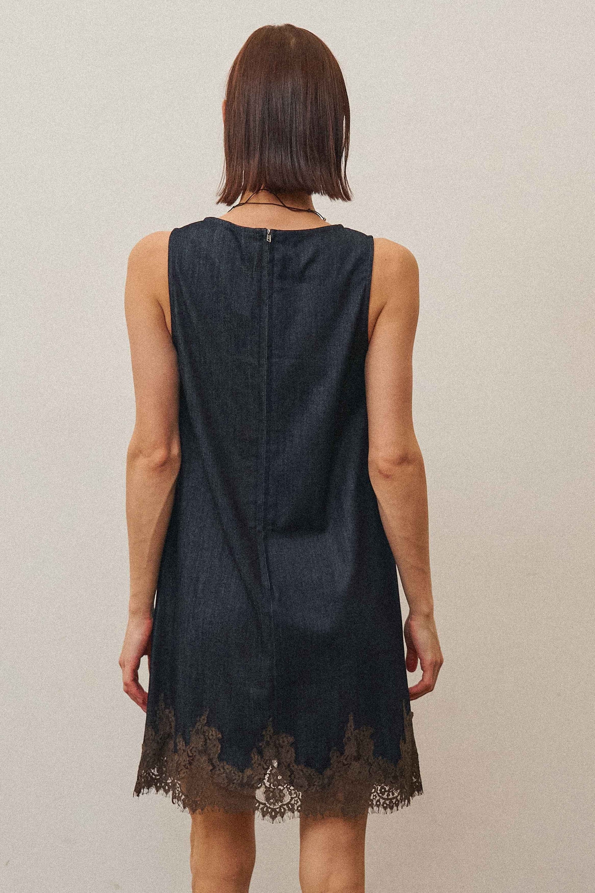 A feminine denim shift dress featuring delicate lace trim, a flattering sleeveless silhouette, and soft stretch denim for effortless all-day style.