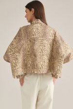 A statement-making animal print jacket featuring dramatic poncho sleeves, a button front, and convenient pockets in a soft cotton-blend fabric.

